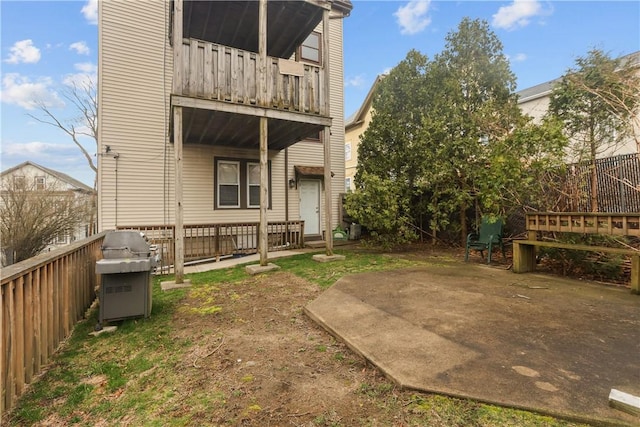 back of house with fence and a balcony