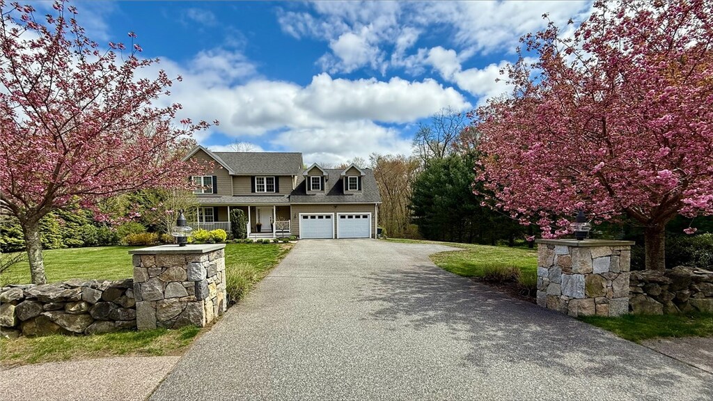 288 Middle Rd, East Greenwich, RI 02818 - view of front facade with a front lawn, driveway, and covered porch