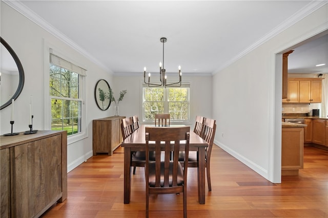 dining space featuring plenty of natural light, baseboards, an inviting chandelier, and light wood-type flooring