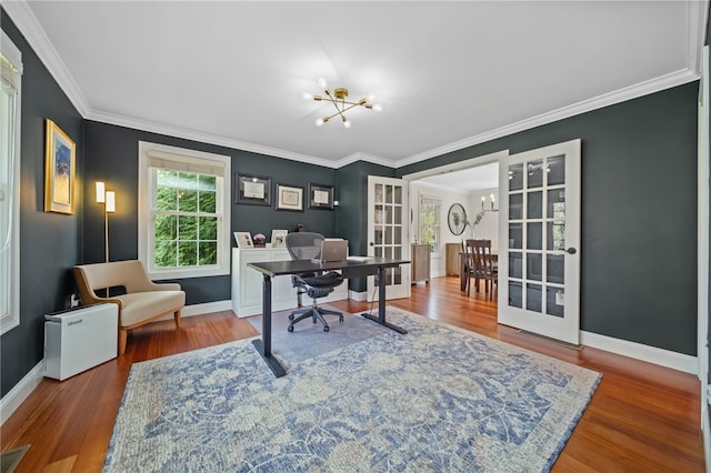 home office featuring crown molding, a notable chandelier, baseboards, wood finished floors, and visible vents