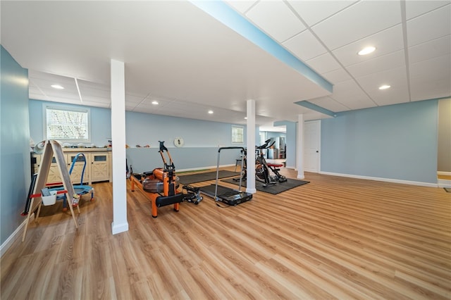 workout room featuring recessed lighting, baseboards, and wood finished floors