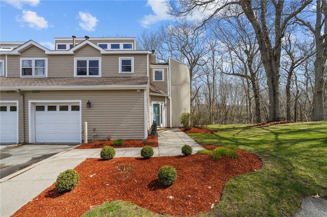 view of front facade with a garage, driveway, and a front lawn