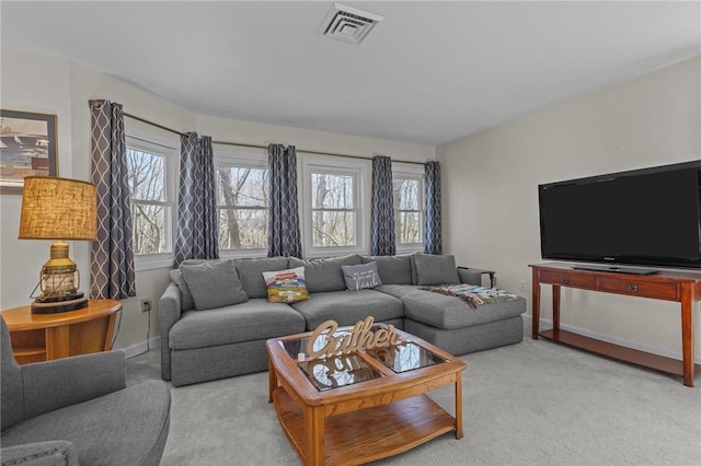 living room with baseboards, visible vents, and light colored carpet