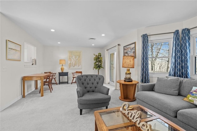 living room with baseboards, light carpet, visible vents, and recessed lighting
