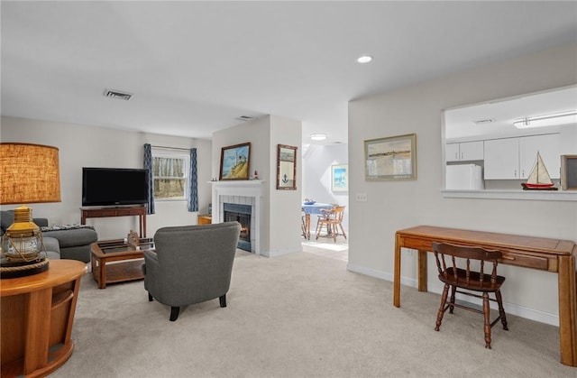 carpeted living area with a fireplace, visible vents, baseboards, and recessed lighting
