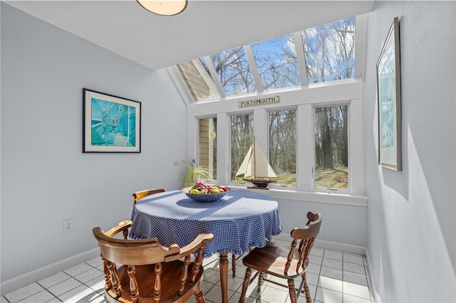 dining room with baseboards, a healthy amount of sunlight, and light tile patterned flooring