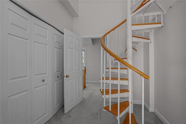 stairway featuring carpet flooring and baseboards