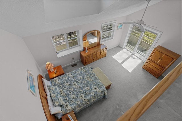 carpeted bedroom with lofted ceiling, visible vents, and access to outside