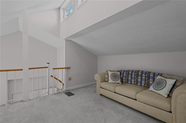 carpeted living area with vaulted ceiling and baseboards
