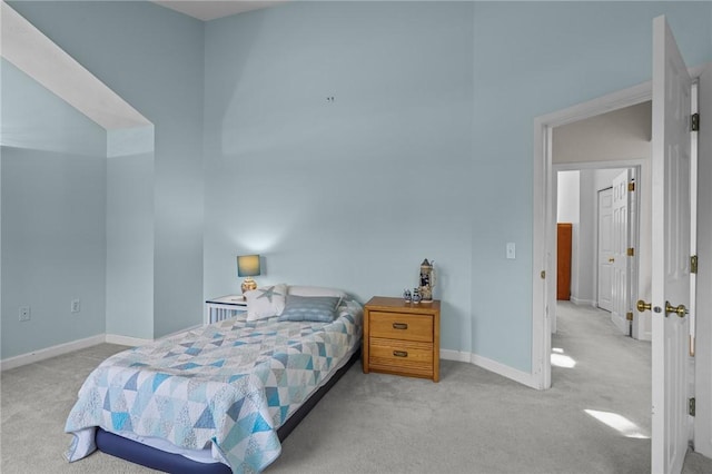 carpeted bedroom featuring baseboards