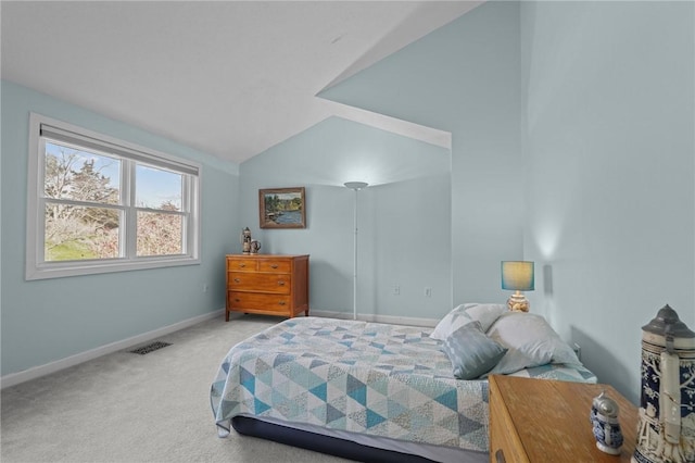 carpeted bedroom featuring baseboards, vaulted ceiling, and visible vents