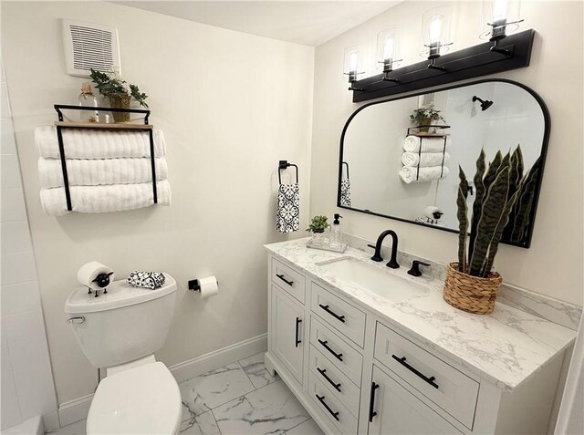 bathroom with toilet, baseboards, marble finish floor, and vanity