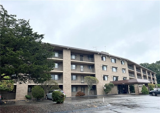view of building exterior with uncovered parking