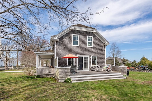 back of house with a deck and a yard