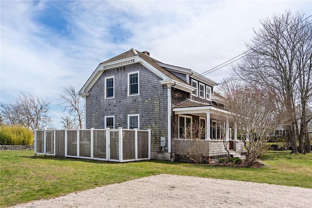 exterior space featuring a chimney and a yard