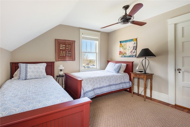 bedroom featuring wood finished floors, ceiling fan, vaulted ceiling, and baseboards