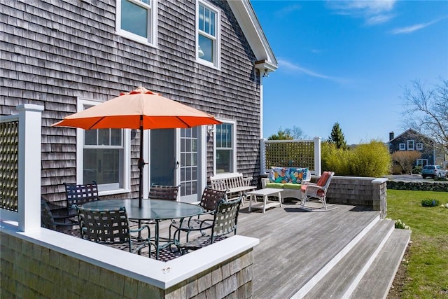 wooden terrace with outdoor lounge area and outdoor dining space