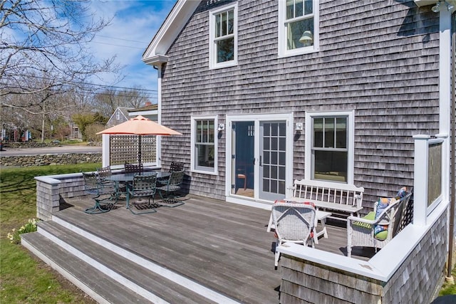 wooden terrace featuring outdoor dining space