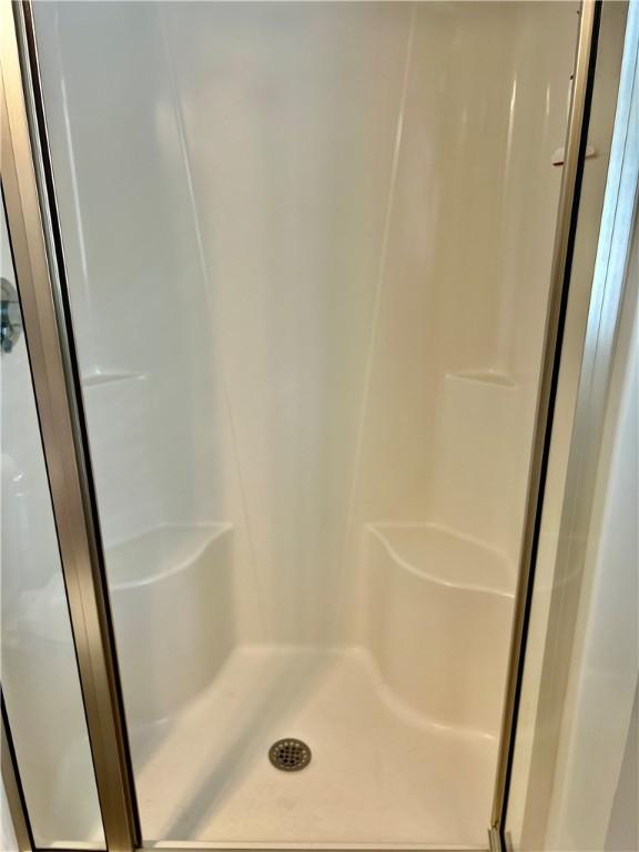 full bathroom featuring a shower stall