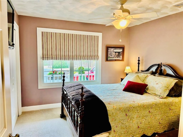 bedroom featuring ceiling fan, carpet floors, visible vents, and baseboards