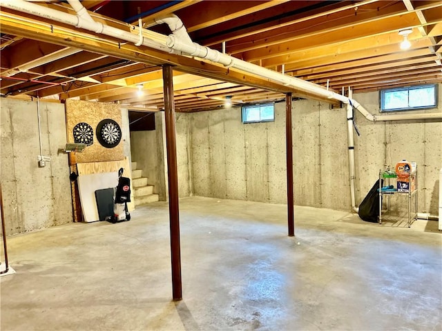 basement featuring stairs and plenty of natural light