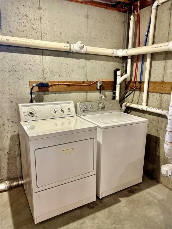 clothes washing area with washer and dryer and laundry area