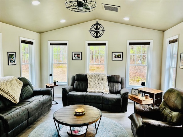 living room with lofted ceiling, plenty of natural light, visible vents, and recessed lighting