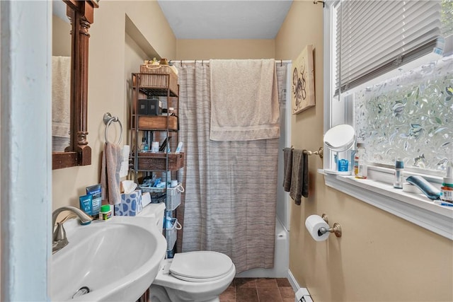 full bathroom featuring toilet, tile patterned flooring, a sink, and shower / bathtub combination with curtain