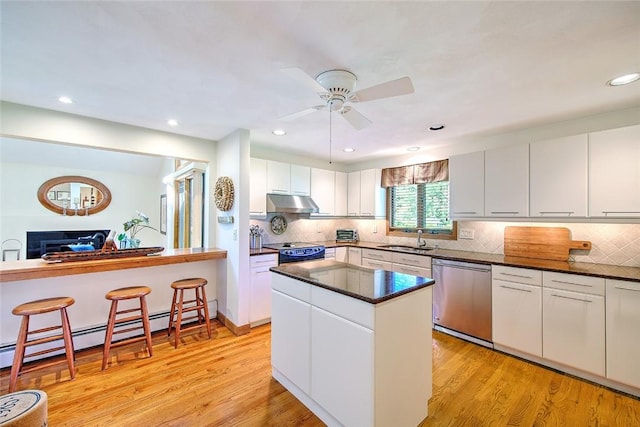 21 Fesser Ave, Bristol, RI 02809 - kitchen with stainless steel dishwasher, electric stove, a sink, light wood-type flooring, and under cabinet range hood