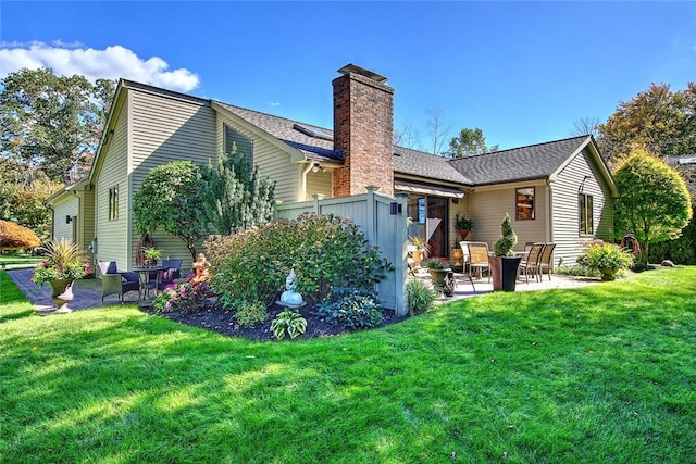 21 Fesser Ave, Bristol, RI 02809 - back of house featuring a patio area, a lawn, and a chimney