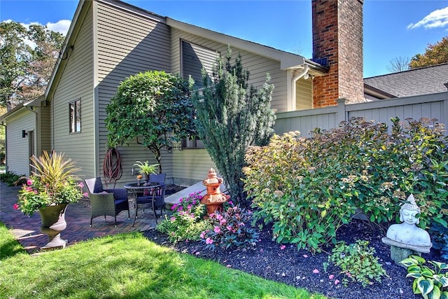 21 Fesser Ave, Bristol, RI 02809 - view of side of home with a patio area, a chimney, and fence