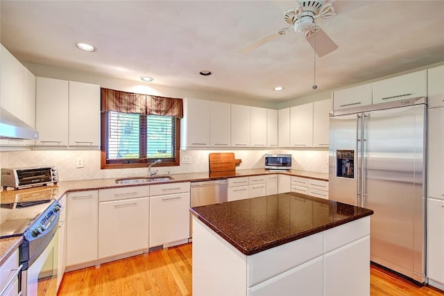 21 Fesser Ave, Bristol, RI 02809 - kitchen with a ceiling fan, a sink, decorative backsplash, a toaster, and stainless steel appliances