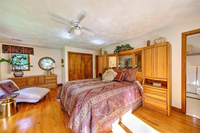 21 Fesser Ave, Bristol, RI 02809 - bedroom with light wood finished floors, visible vents, a ceiling fan, a closet, and a baseboard radiator