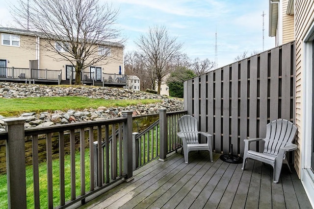 wooden deck featuring a yard