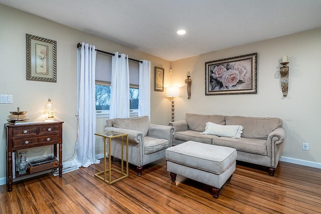 living area with baseboards, wood finished floors, and recessed lighting