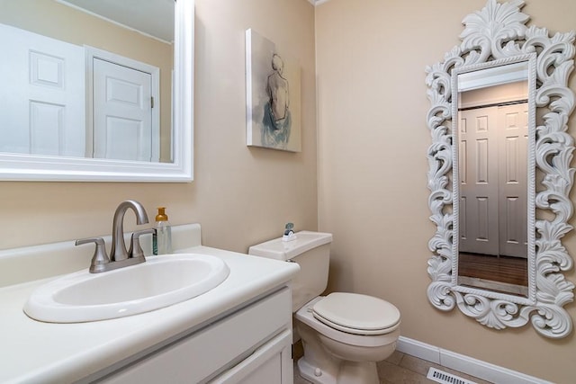 bathroom featuring tile patterned floors, vanity, and toilet