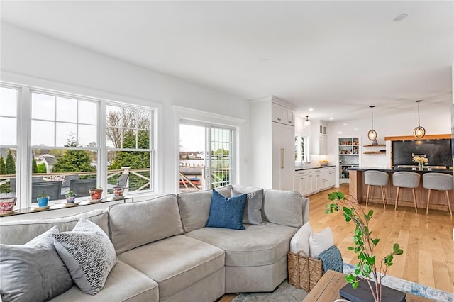 living area featuring recessed lighting and light wood-style flooring