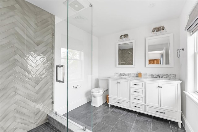 full bath with double vanity, baseboards, a stall shower, and a sink