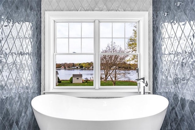 full bath featuring a wealth of natural light and a soaking tub