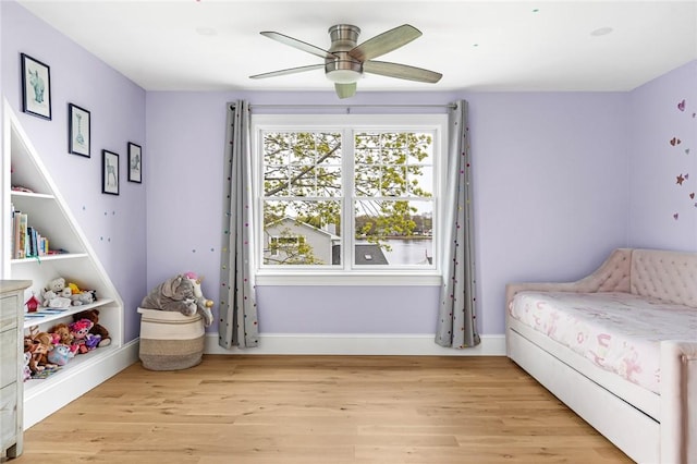 bedroom featuring baseboards, ceiling fan, and light wood-type flooring
