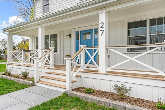 property entrance with covered porch and board and batten siding