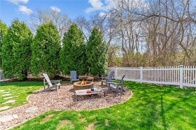 view of yard with an outdoor fire pit and fence