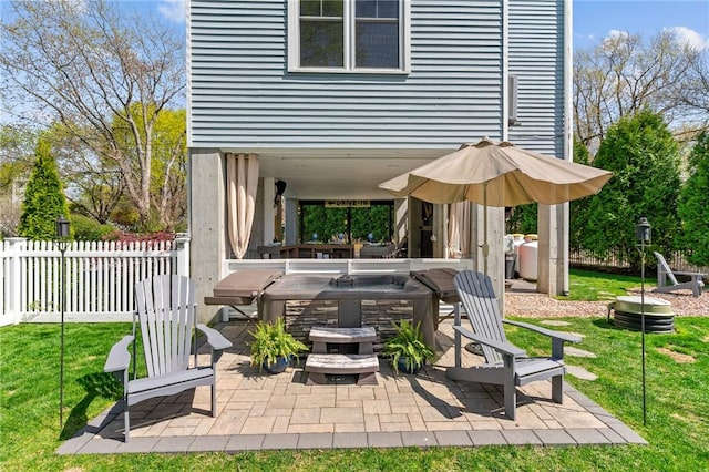 view of patio / terrace featuring fence and a hot tub