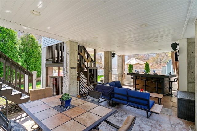 view of patio / terrace with outdoor lounge area, outdoor dining area, and stairs
