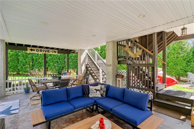 view of patio / terrace with outdoor lounge area, outdoor dining area, and stairs