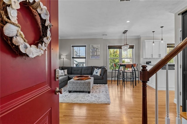 living room featuring recessed lighting, stairway, visible vents, light wood-type flooring, and crown molding