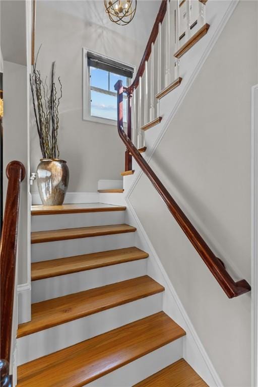 stairway with an inviting chandelier