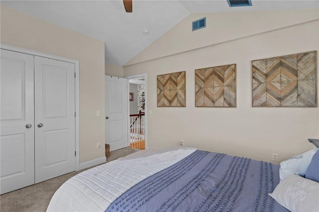carpeted bedroom with lofted ceiling, a ceiling fan, visible vents, and a closet