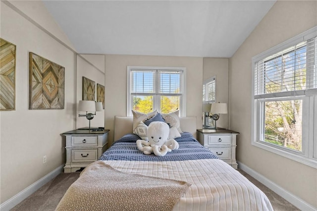 carpeted bedroom featuring vaulted ceiling, baseboards, and multiple windows