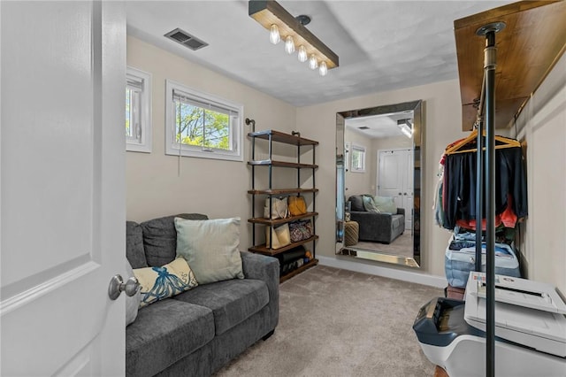 sitting room featuring carpet floors, visible vents, and baseboards